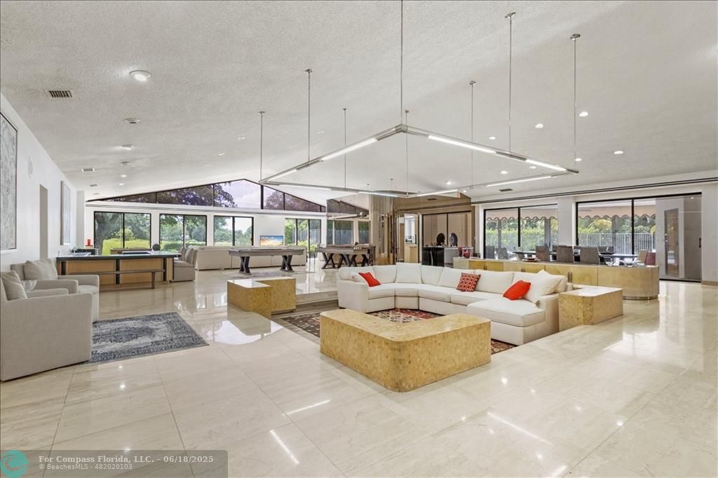 5304 Woodlands Boulevard Tamarac, FL 33319 - Photo 5 of 57 a living room with patio furniture and a large window