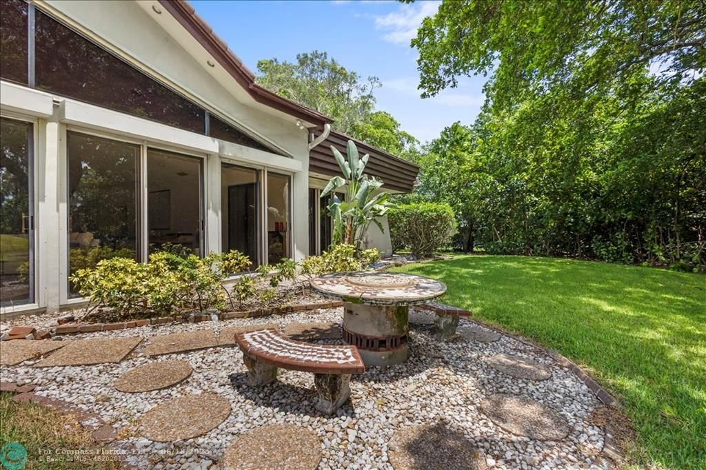 5304 Woodlands Boulevard Tamarac, FL 33319 - Photo 54 of 57 a view of a backyard with garden and patio