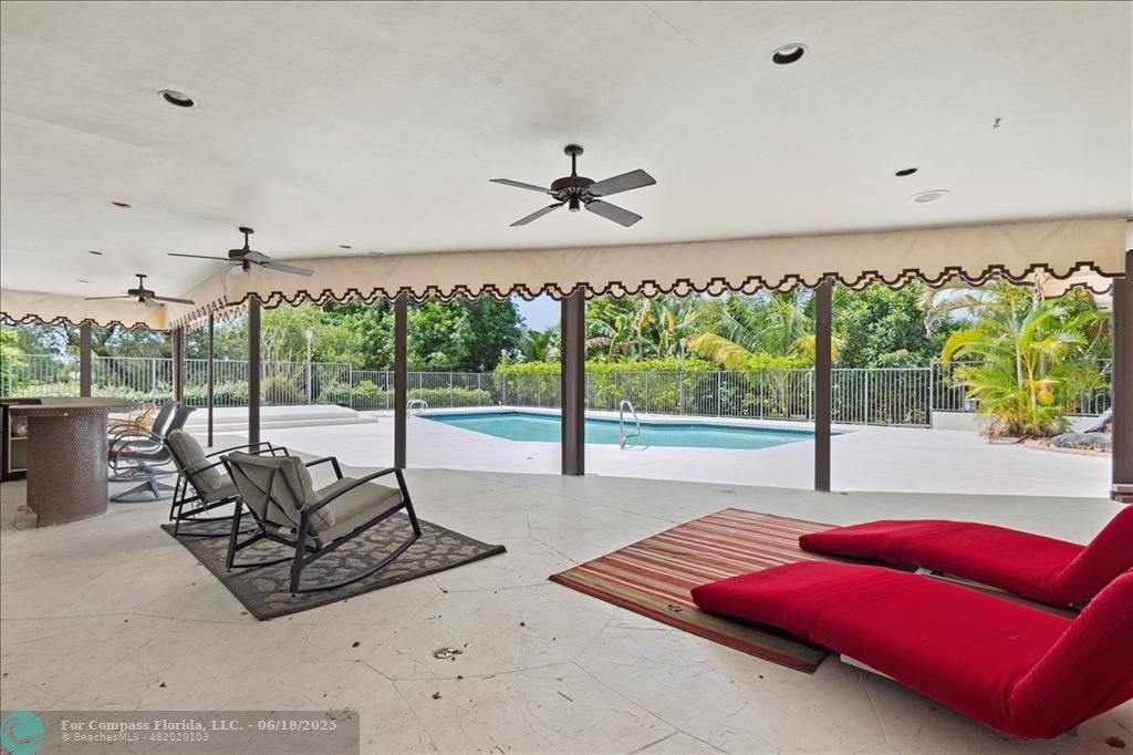 5304 Woodlands Boulevard Tamarac, FL 33319 - Photo 55 of 57 a living room with furniture a flat screen tv and a large window