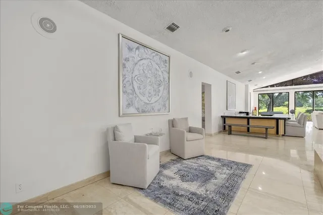 a living room with furniture a rug and a large window
