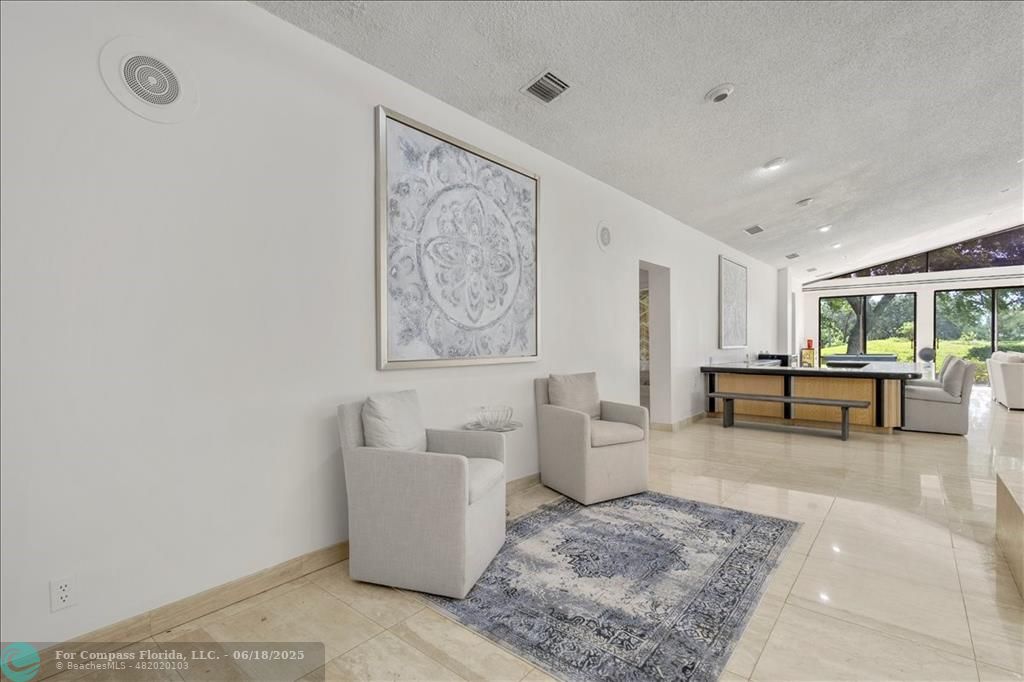5304 Woodlands Boulevard Tamarac, FL 33319 - Photo 8 of 57 a living room with furniture and a table