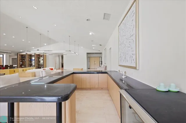 a living room with furniture large windows and a flat screen tv