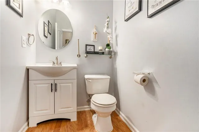 a bathroom with a toilet a sink and mirror