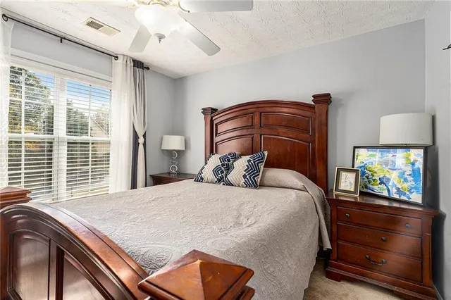 a bedroom with a bed and a large window