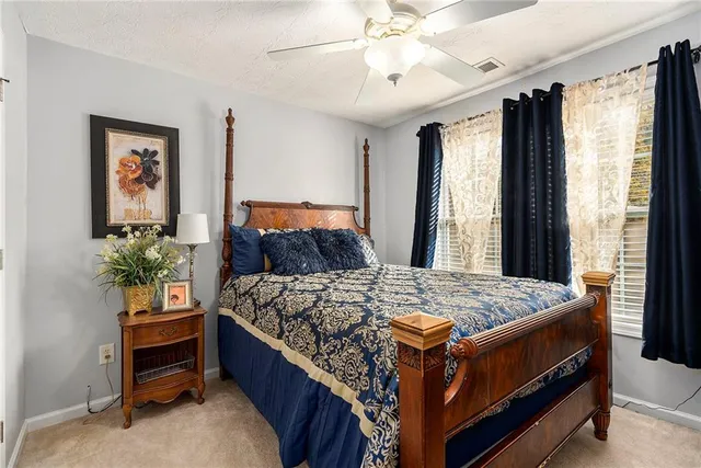 a bed sitting in a bedroom next to a window