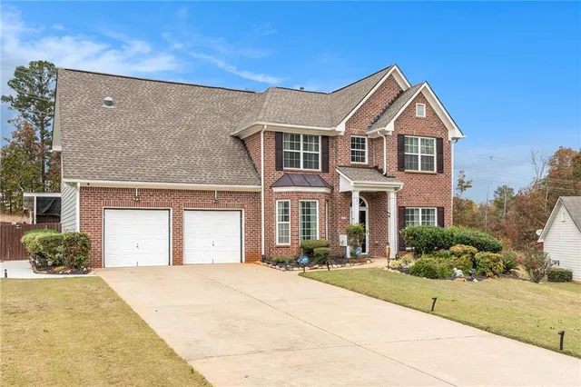 a front view of a house with a yard