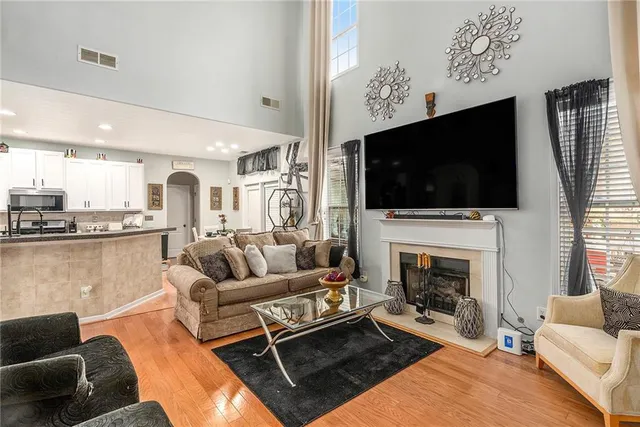 a living room with fireplace furniture and a flat screen tv