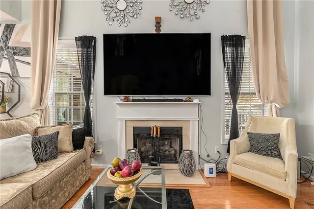 a living room with furniture a flat screen tv and a fireplace