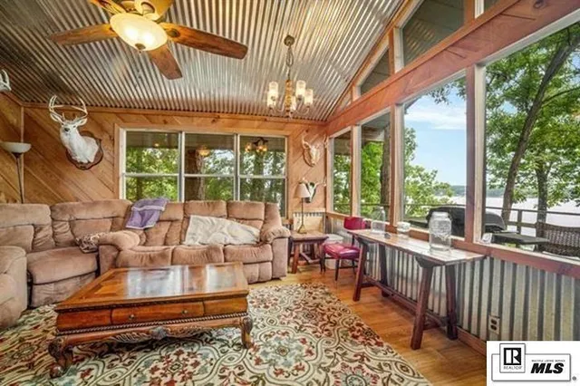 a roof deck with table and chairs and potted plants