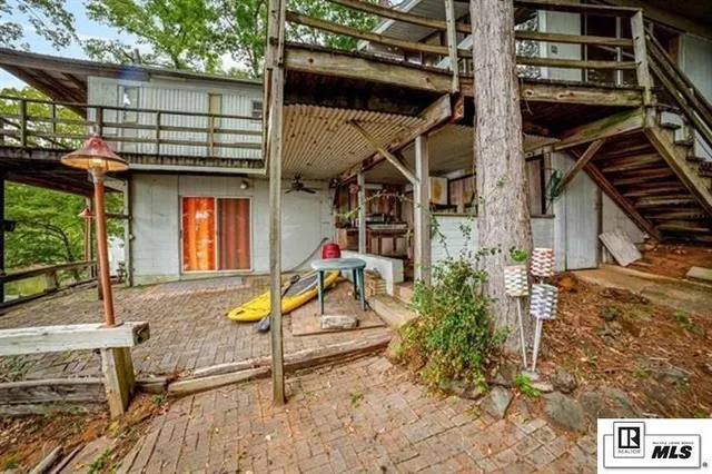 a view of a house with backyard and wooden fence