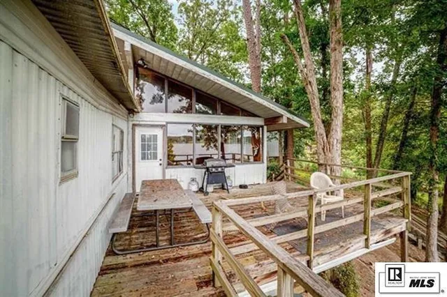 a view of a patio with table and chairs next to a yard