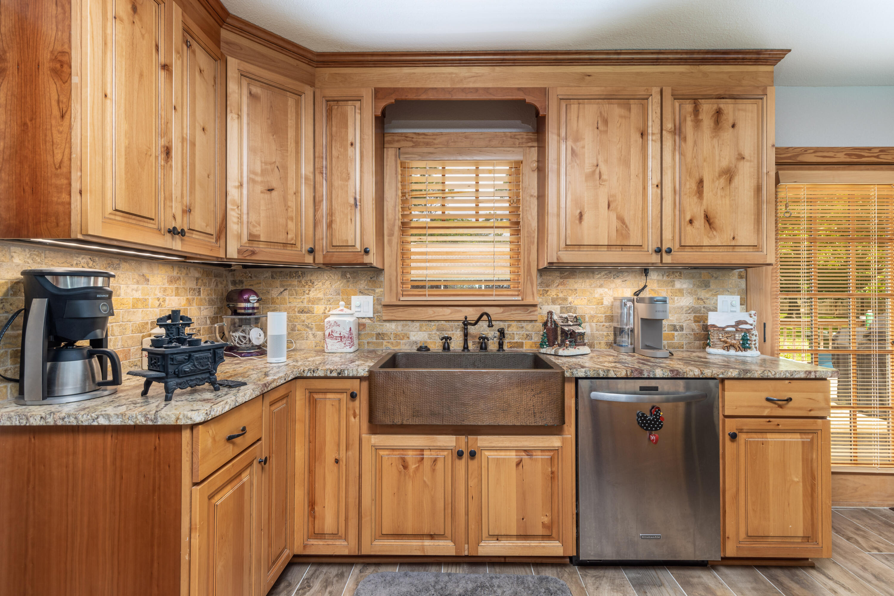 a kitchen with stainless steel appliances granite countertop a sink a stove and cabinets