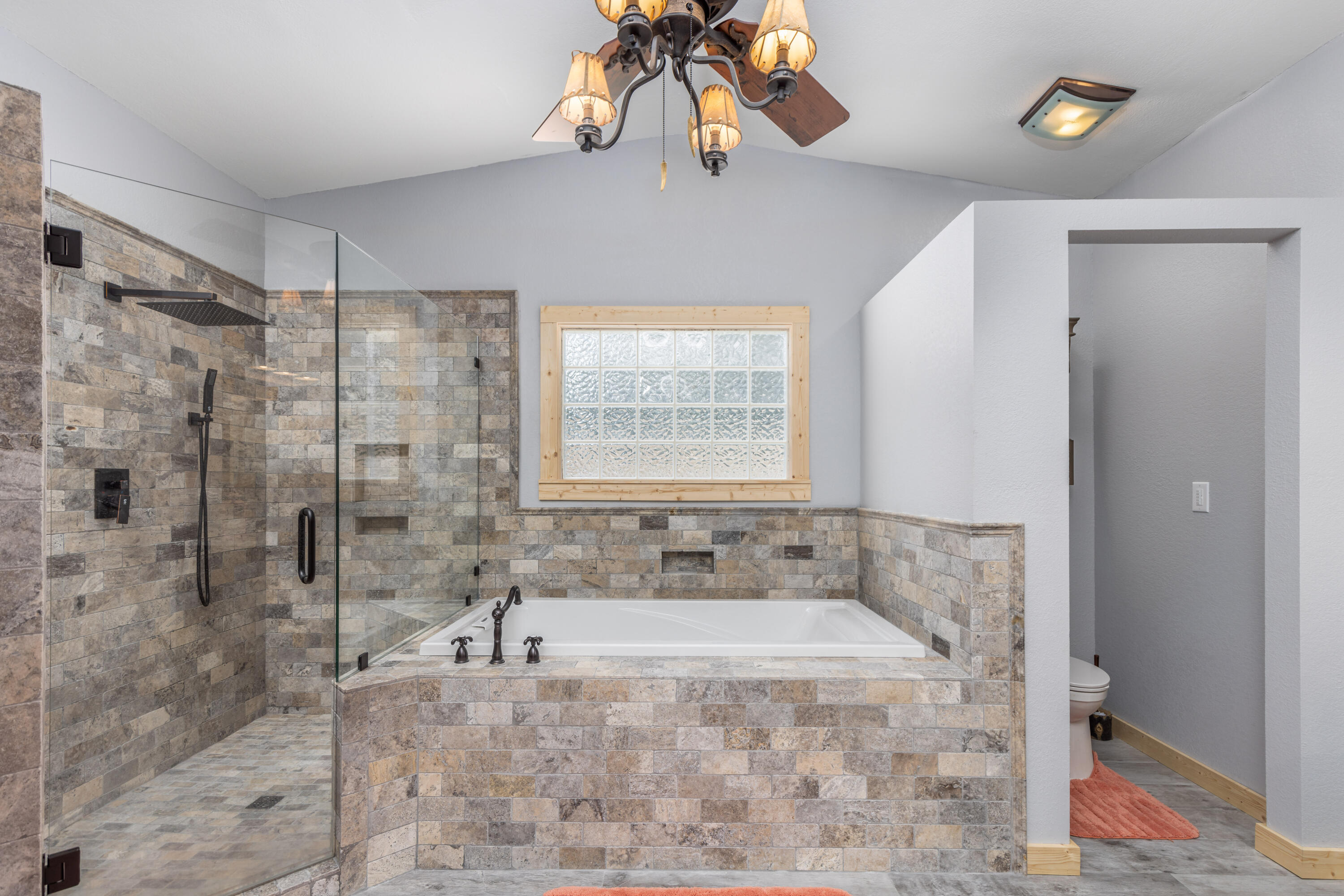229 Madrid Road Cantonment, FL 32533 - Photo 12 of 84 a spacious bathroom with a granite countertop sink a large mirror and shower
