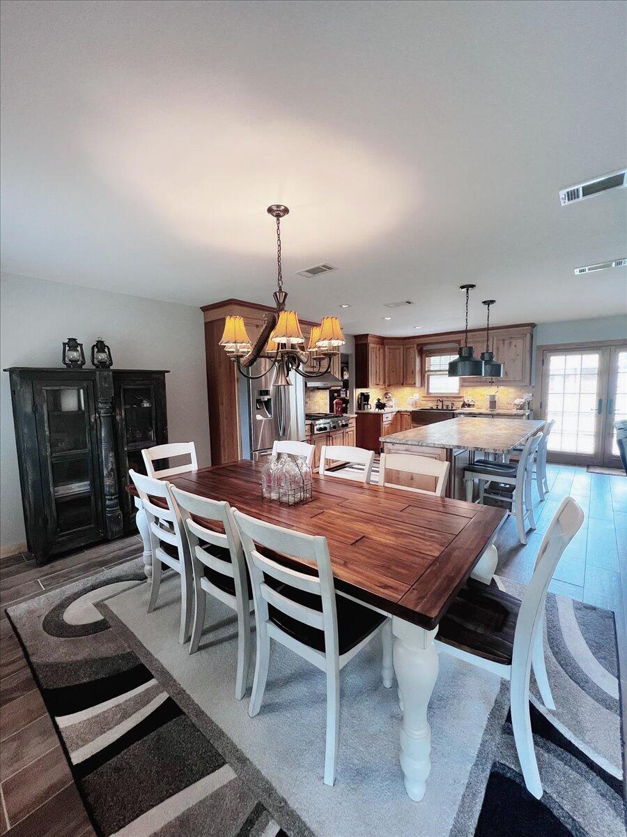 229 Madrid Road Cantonment, FL 32533 - Photo 21 of 84 a dining room with furniture and wooden floor