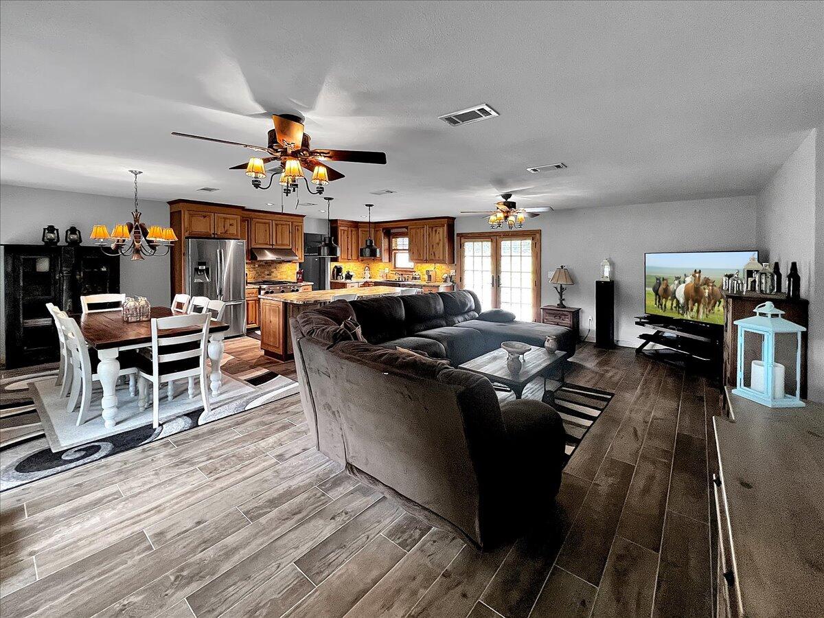 229 Madrid Road Cantonment, FL 32533 - Photo 31 of 84 a living room with furniture kitchen view and a chandelier