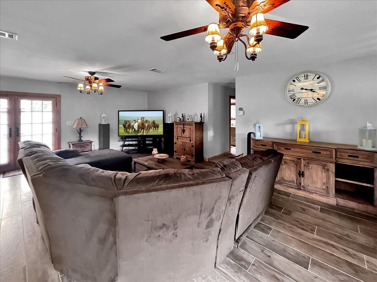 229 Madrid Road Cantonment, FL 32533 - Photo 33 of 84 a living room with fireplace furniture and a chandelier