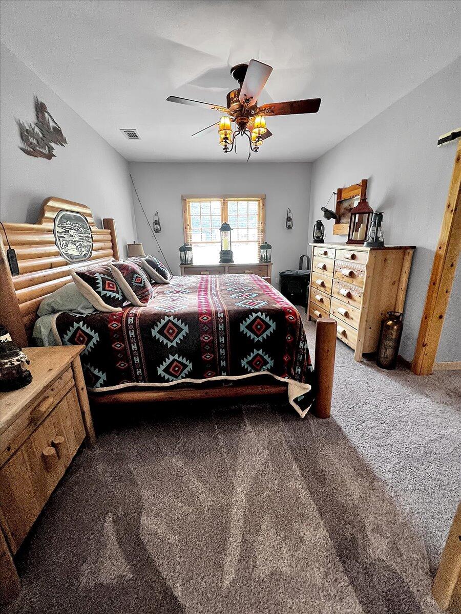 229 Madrid Road Cantonment, FL 32533 - Photo 35 of 84 a bed room with a bed and a chandelier