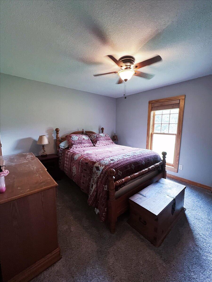 229 Madrid Road Cantonment, FL 32533 - Photo 38 of 84 a bedroom with bed and a chandelier
