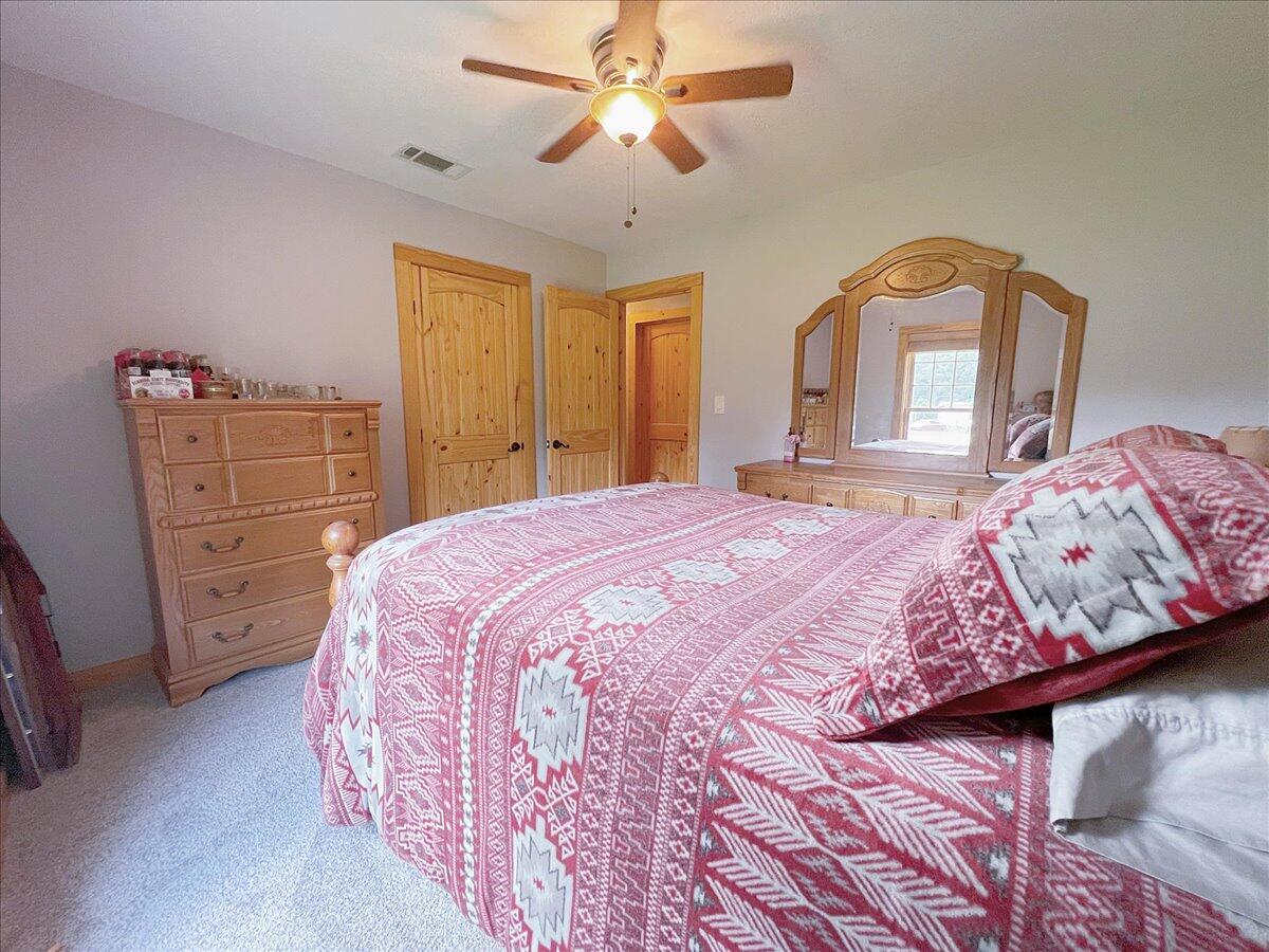 229 Madrid Road Cantonment, FL 32533 - Photo 39 of 84 a bedroom with a bed and a dresser