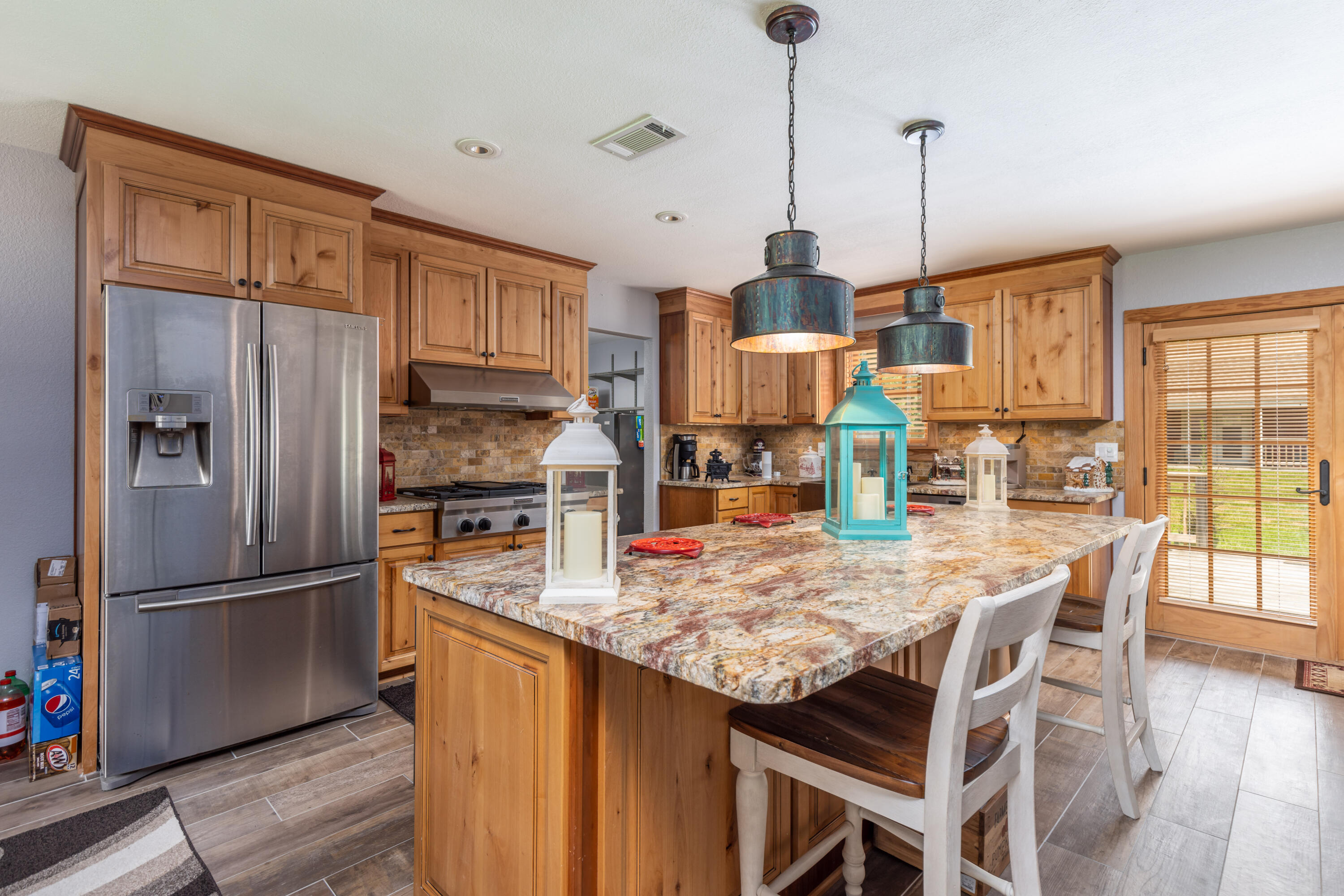 229 Madrid Road Cantonment, FL 32533 - Photo 4 of 84 a kitchen with granite countertop a refrigerator and wooden floor