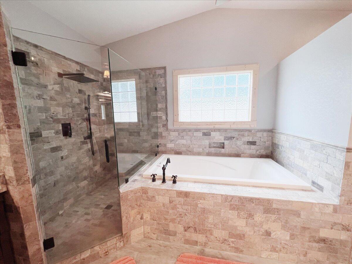 229 Madrid Road Cantonment, FL 32533 - Photo 45 of 84 a bathroom with a bathtub and a shower