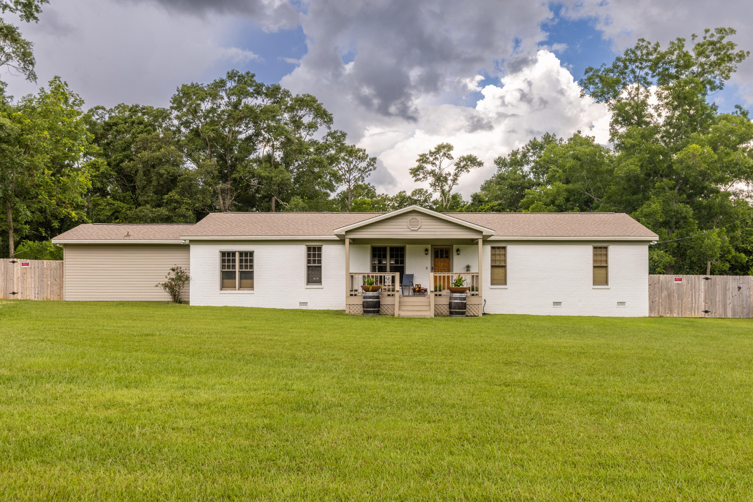 229 Madrid Road Cantonment, FL 32533 - Photo 55 of 84 a front view of a house with yard and garage