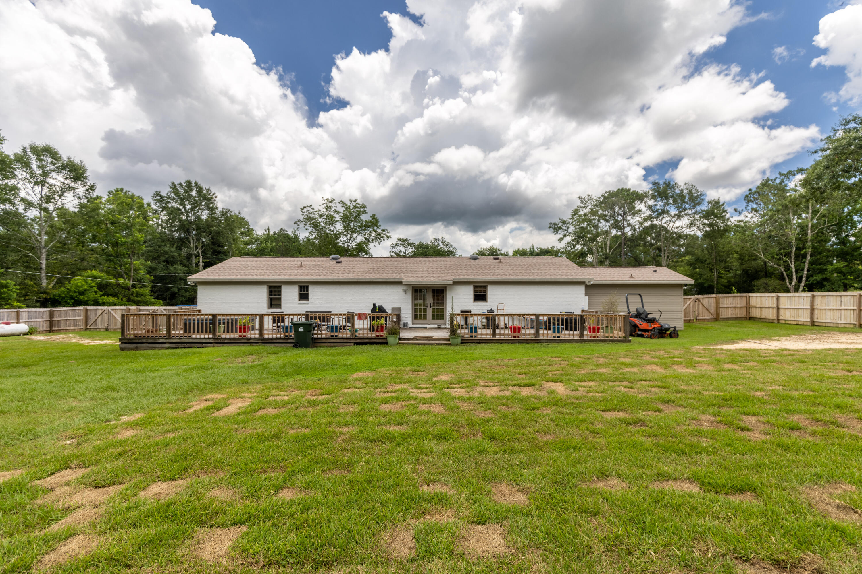 229 Madrid Road Cantonment, FL 32533 - Photo 62 of 84 a view of a house with a big yard and large trees