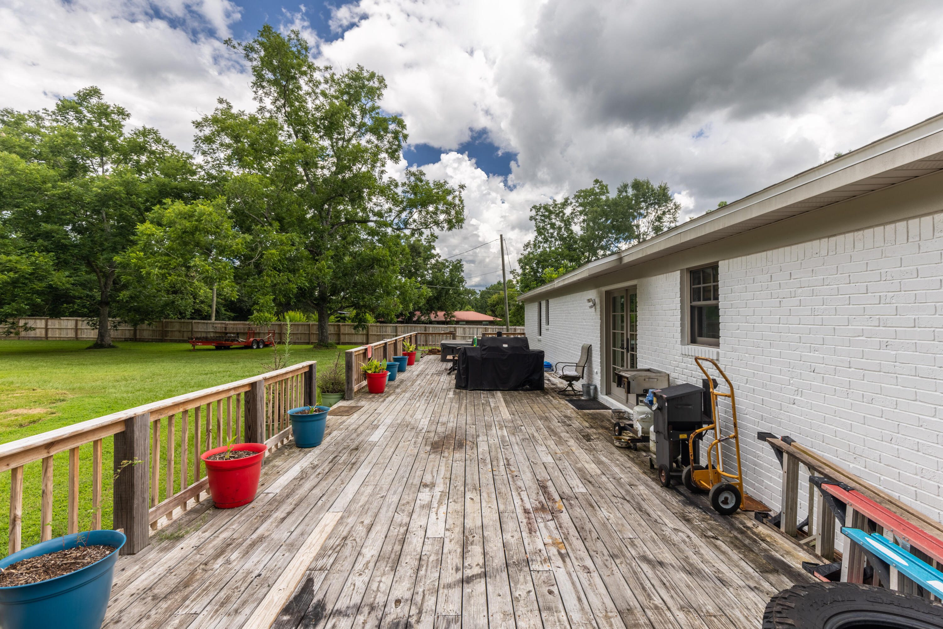 229 Madrid Road Cantonment, FL 32533 - Photo 70 of 84 a view of deck with wooden floor and seating space