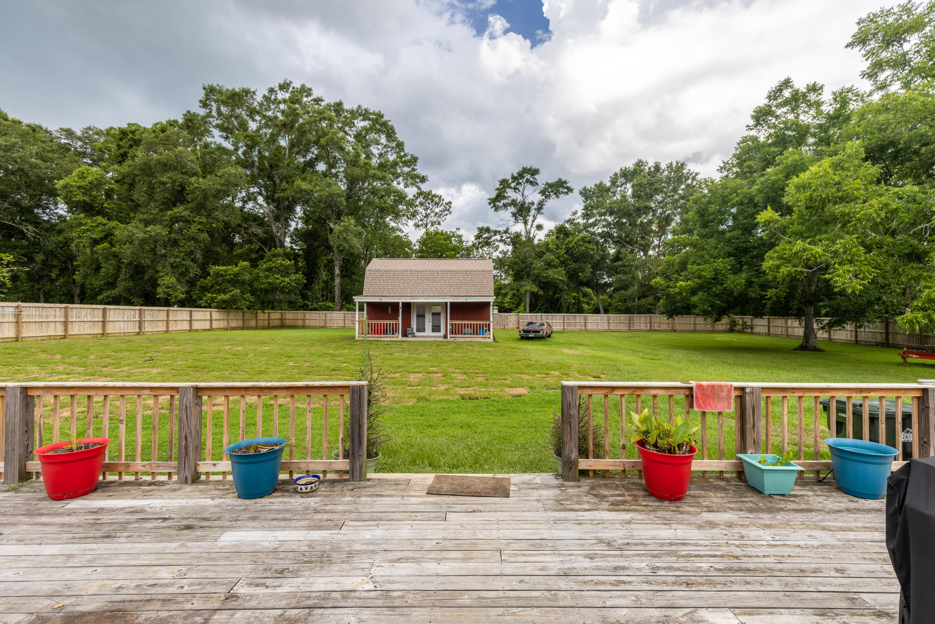 229 Madrid Road Cantonment, FL 32533 - Photo 71 of 84 a view of swimming pool with seating space and trees in the background