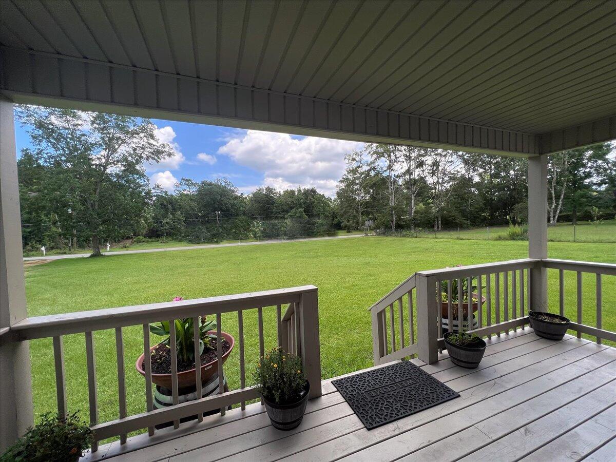 229 Madrid Road Cantonment, FL 32533 - Photo 77 of 84 a view of a wooden deck with a table