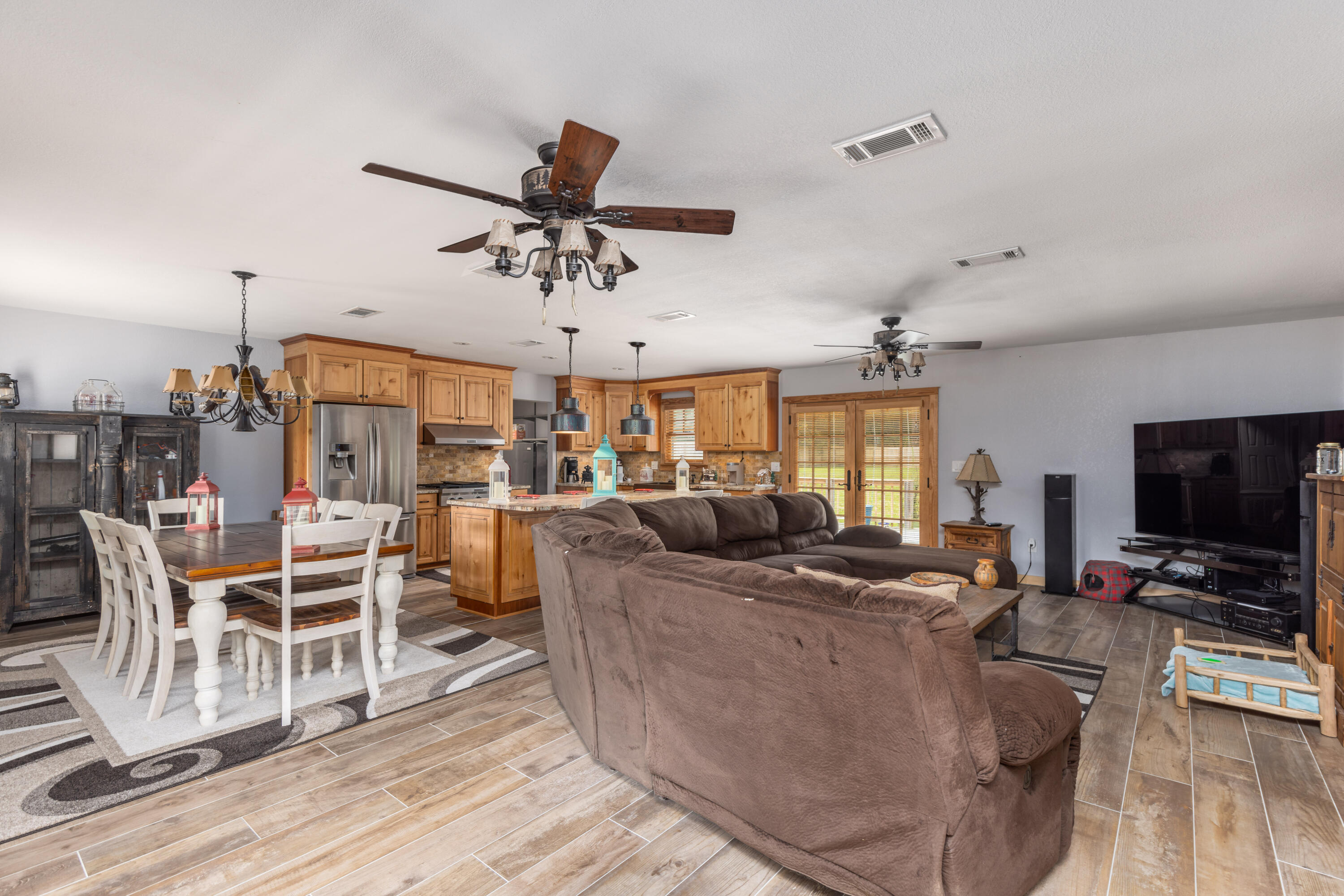 229 Madrid Road Cantonment, FL 32533 - Photo 8 of 84 a living room with furniture a flat screen tv and kitchen view
