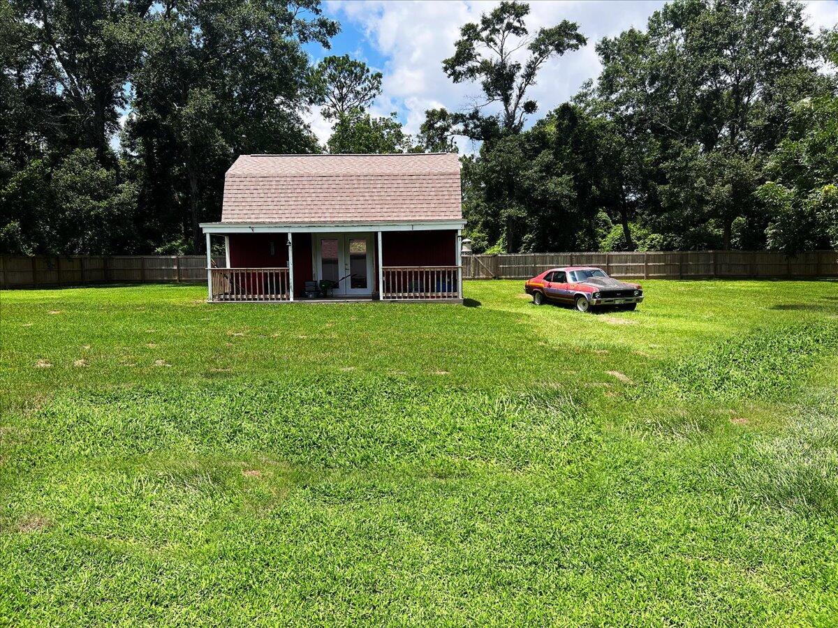 229 Madrid Road Cantonment, FL 32533 - Photo 82 of 84 a view of a house with backyard sitting area and garden