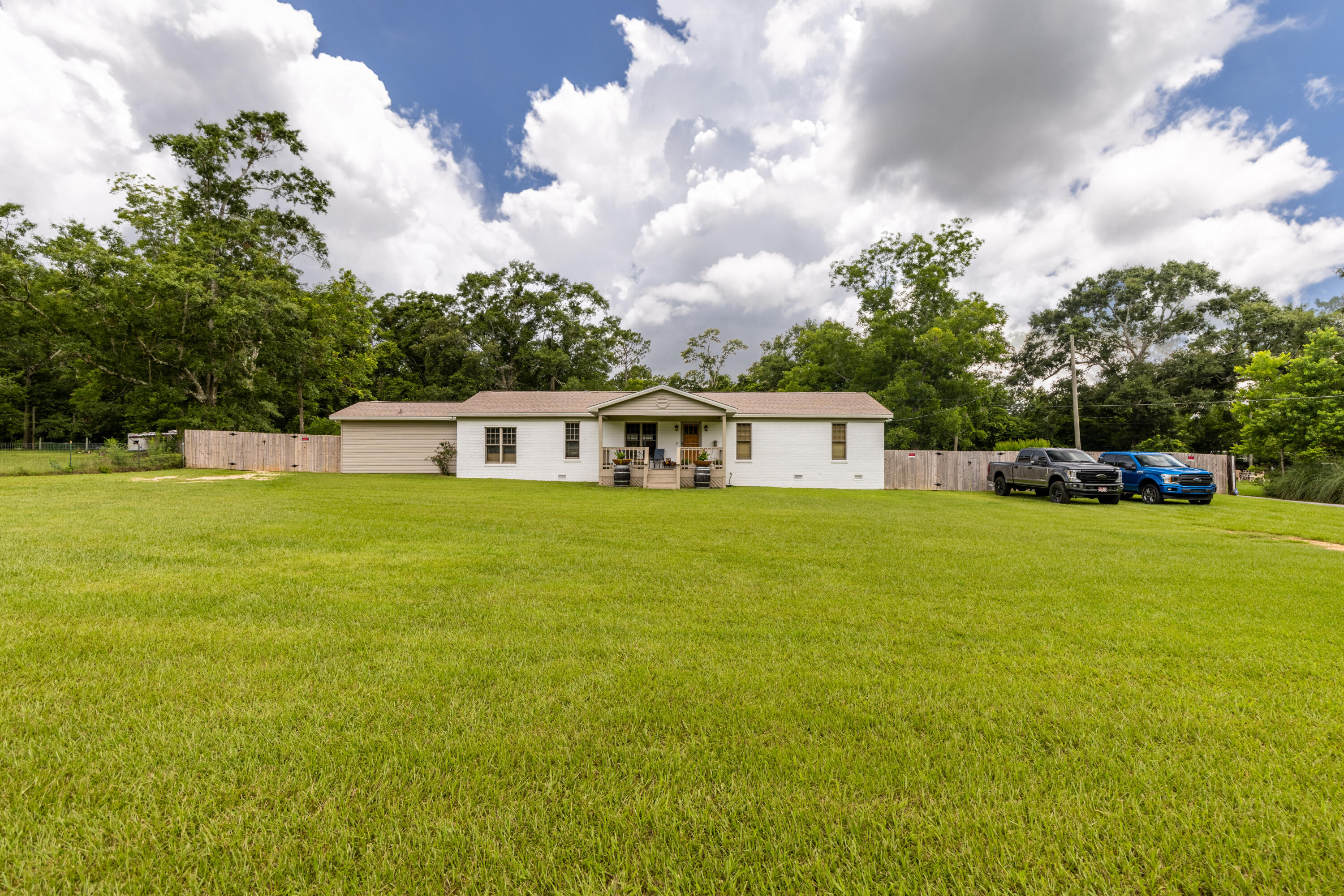 229 Madrid Road Cantonment, FL 32533 - Photo 83 of 84 a front view of house with yard and trees in the background