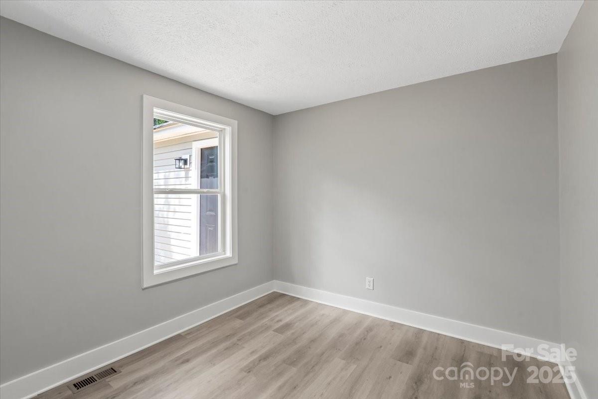 724 Chestnut Street Rock Hill, SC 29730 - Photo 11 of 21 an empty room with wooden floor and windows