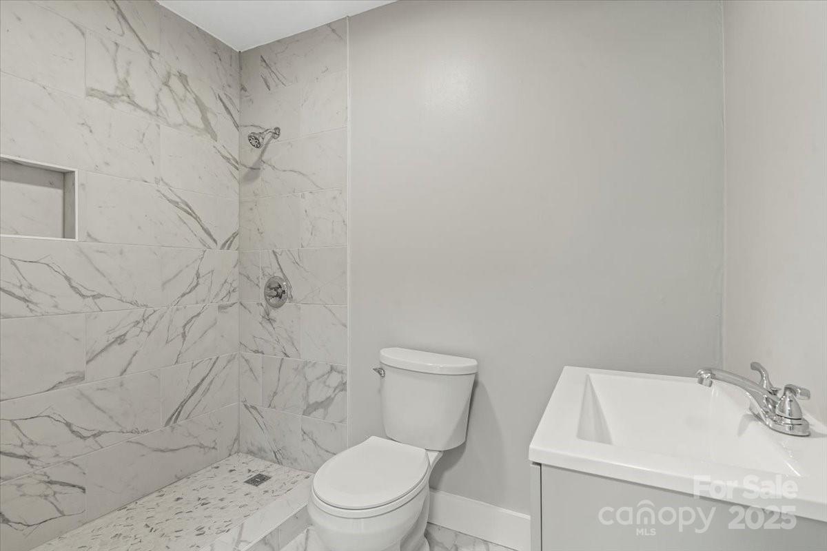 724 Chestnut Street Rock Hill, SC 29730 - Photo 18 of 21 a white toilet sitting next to a white sink and vanity