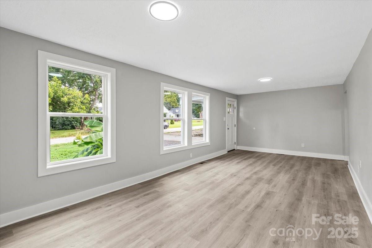 724 Chestnut Street Rock Hill, SC 29730 - Photo 5 of 21 a view of an empty room with wooden floor and a window