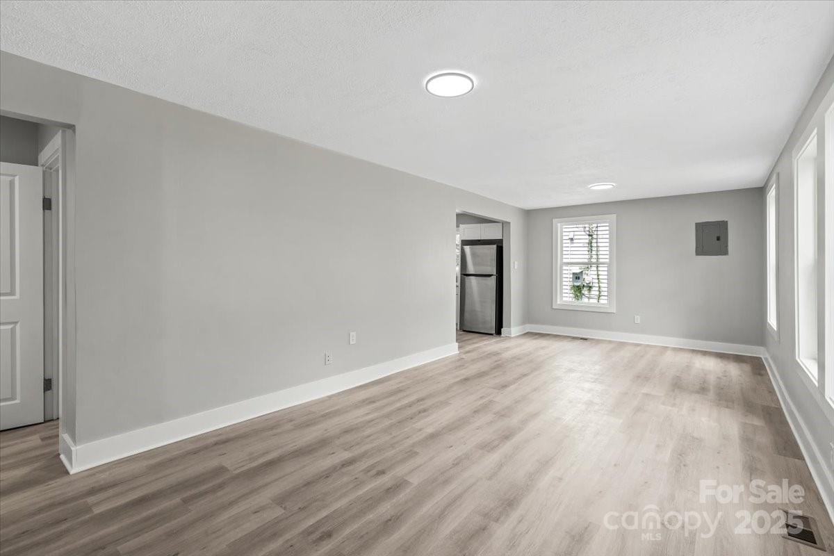 724 Chestnut Street Rock Hill, SC 29730 - Photo 7 of 21 an empty room with wooden floor and windows
