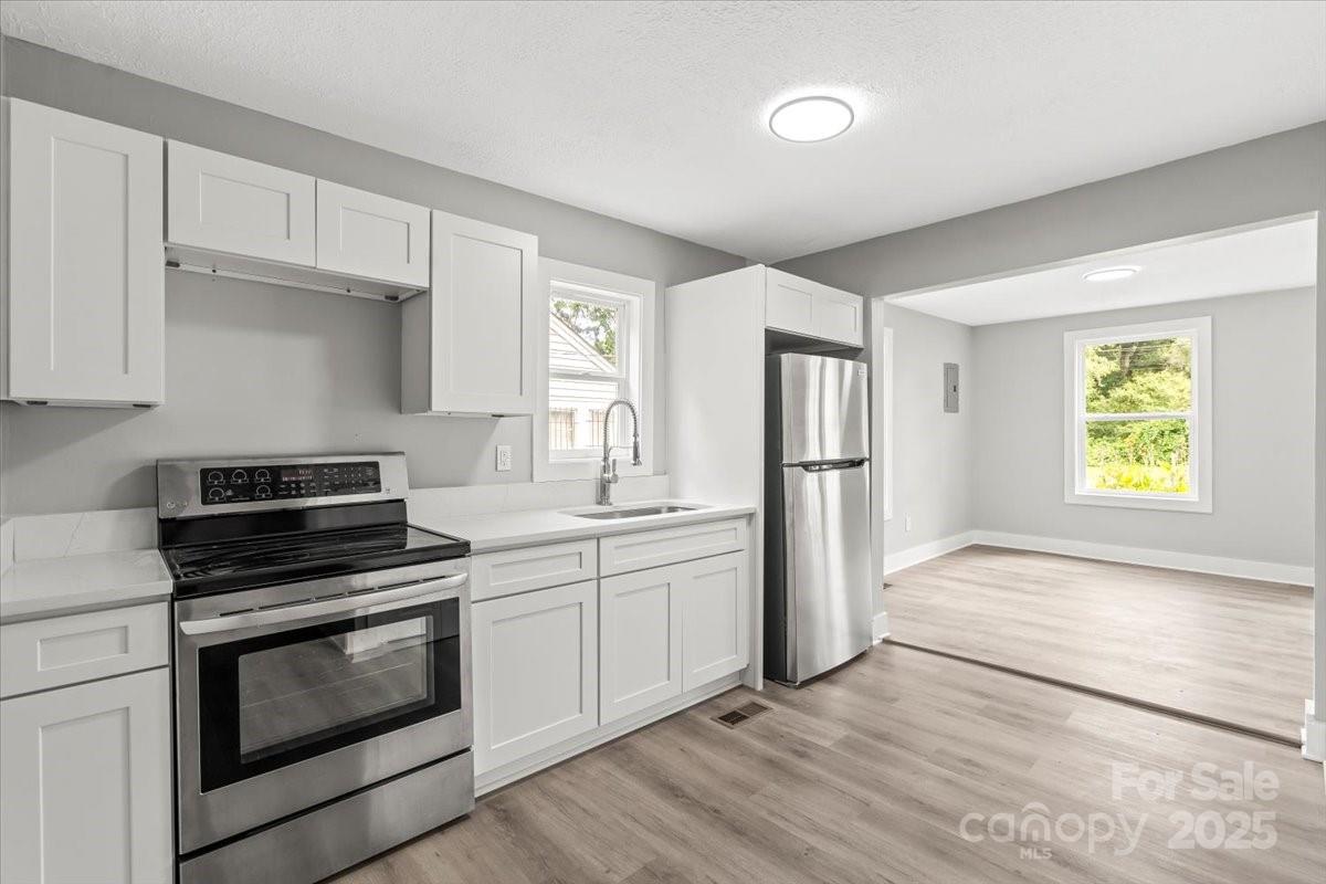 724 Chestnut Street Rock Hill, SC 29730 - Photo 8 of 21 a kitchen with stainless steel appliances granite countertop a stove and a refrigerator