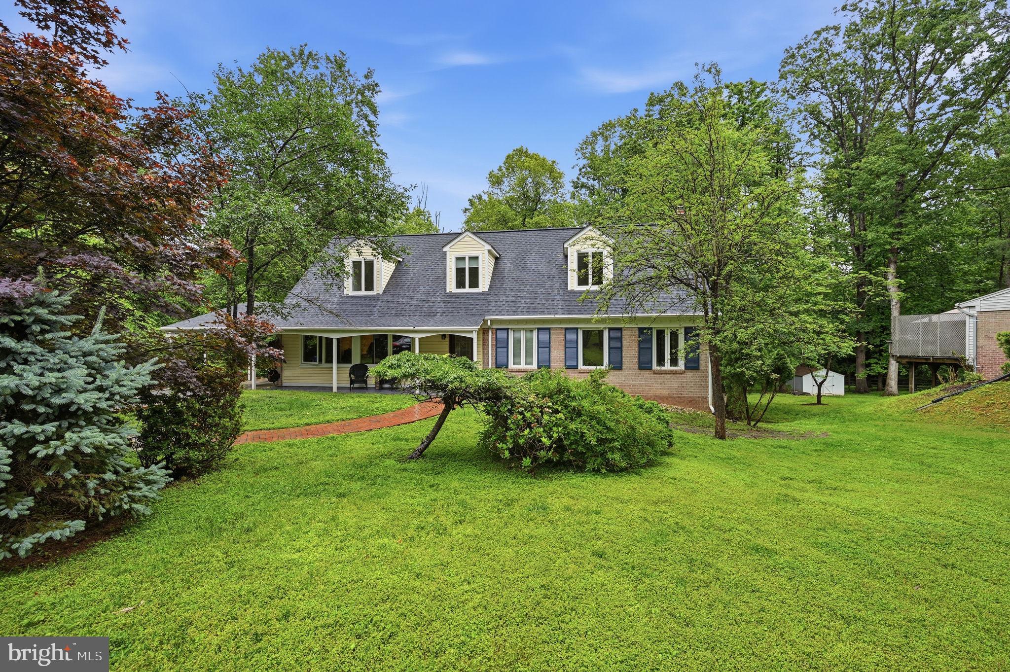 2506 Pinoak Lane Reston, VA 20191 - Photo 2 of 33 a front view of a house with a garden
