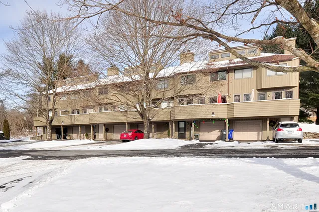 a view of city street with a building and trees