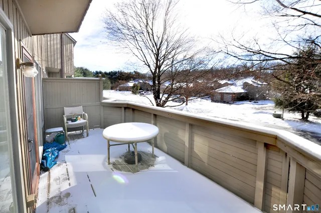 a view of a balcony with chairs and a table