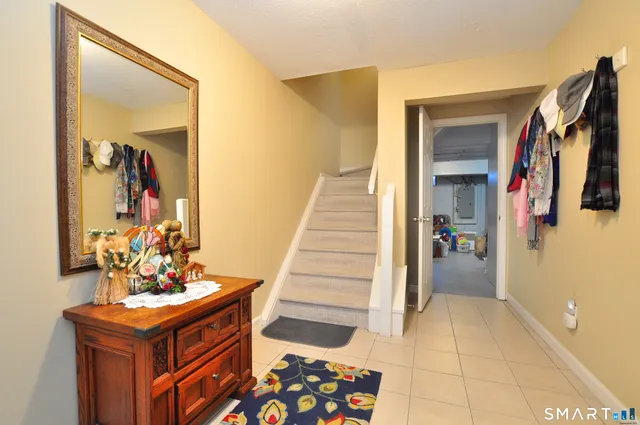 a view of a hallway with closet and a front door