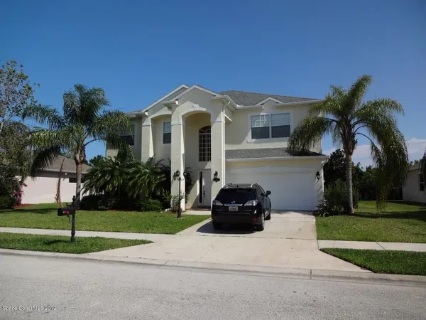 a front view of a house with a garden and a yard