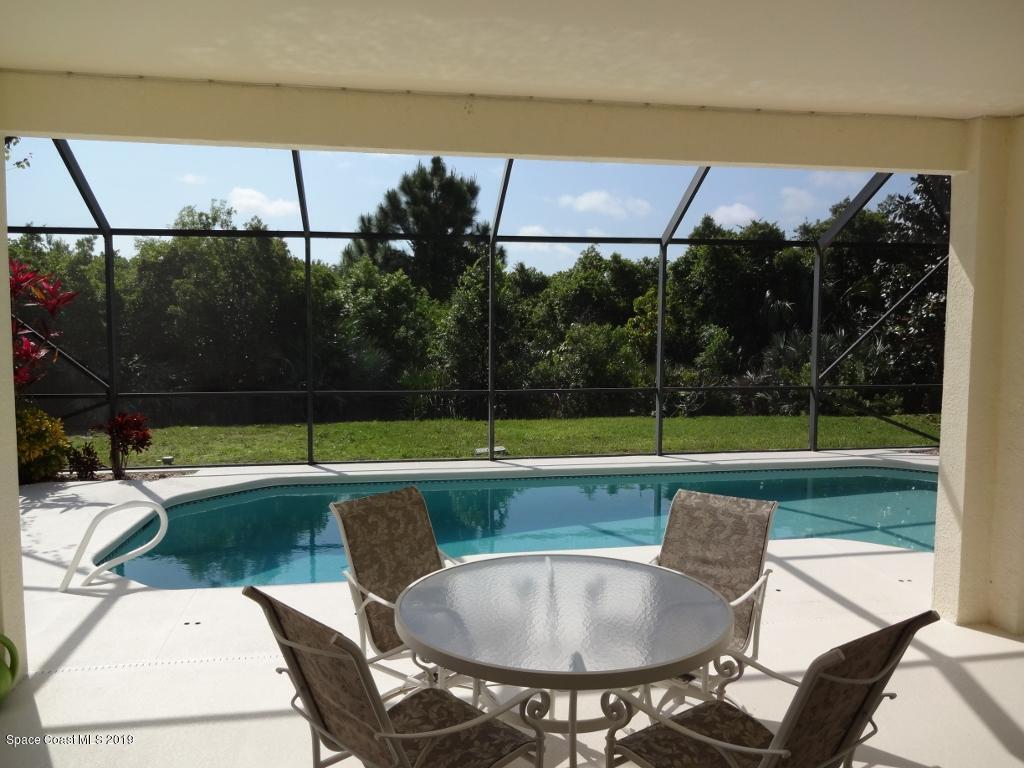 3763 Stream Drive Melbourne, FL 32940 - Photo 5 of 6 a view of yard with swimming pool and outdoor seating