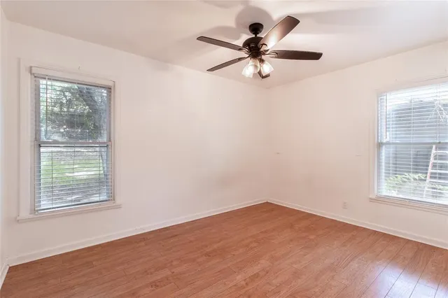 a view of a big room with wooden floor closet and windows