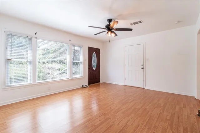 a view of a livingroom with a ceiling fan and window