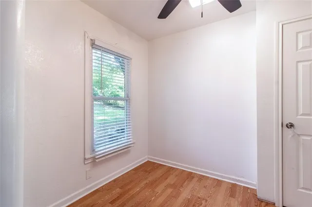an empty room with windows and closet