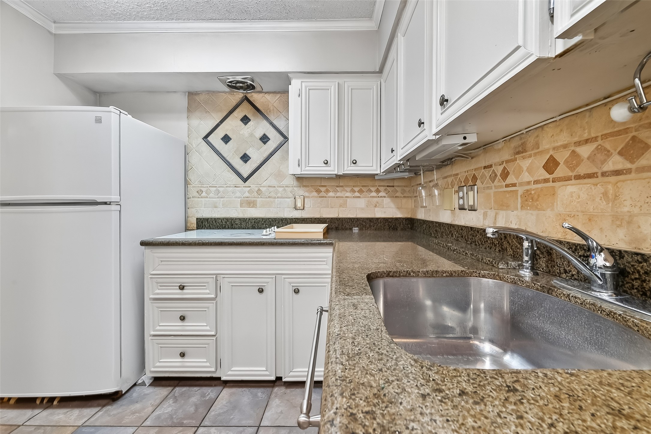 909 Silber Road, Unit 16C Houston, TX 77024 - Photo 17 of 32 a view of a kitchen with a sink and dishwasher