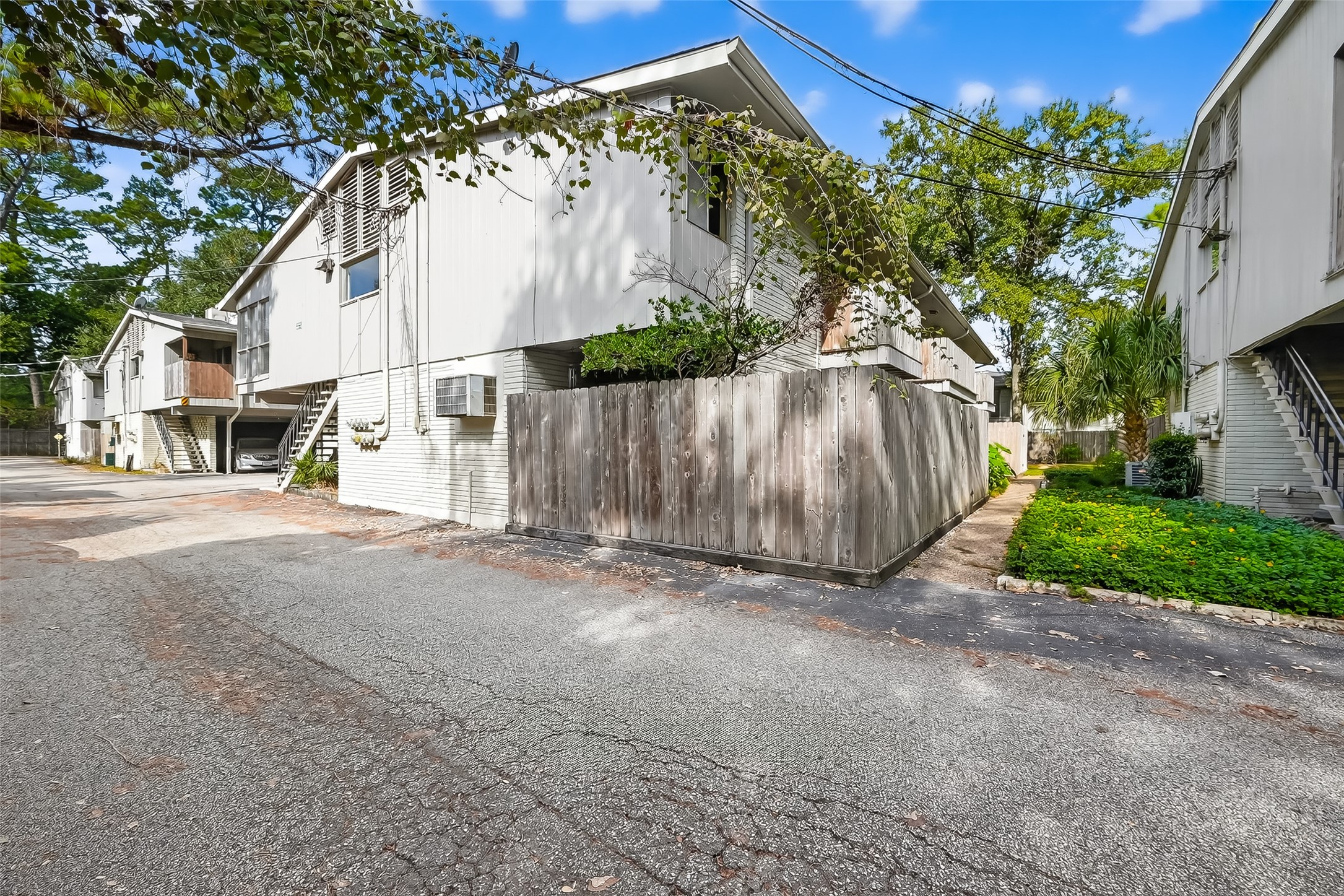 909 Silber Road, Unit 16C Houston, TX 77024 - Photo 2 of 32 a view of a house with a yard and garage