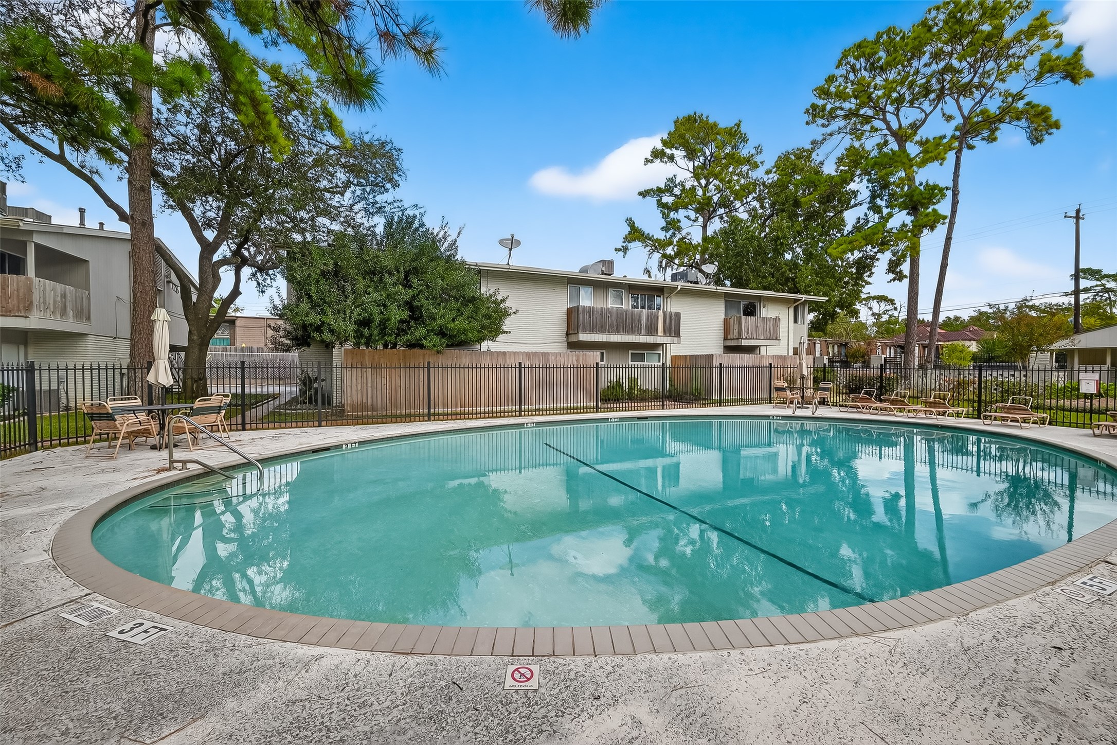 909 Silber Road, Unit 16C Houston, TX 77024 - Photo 31 of 32 a view of a swimming pool with a patio